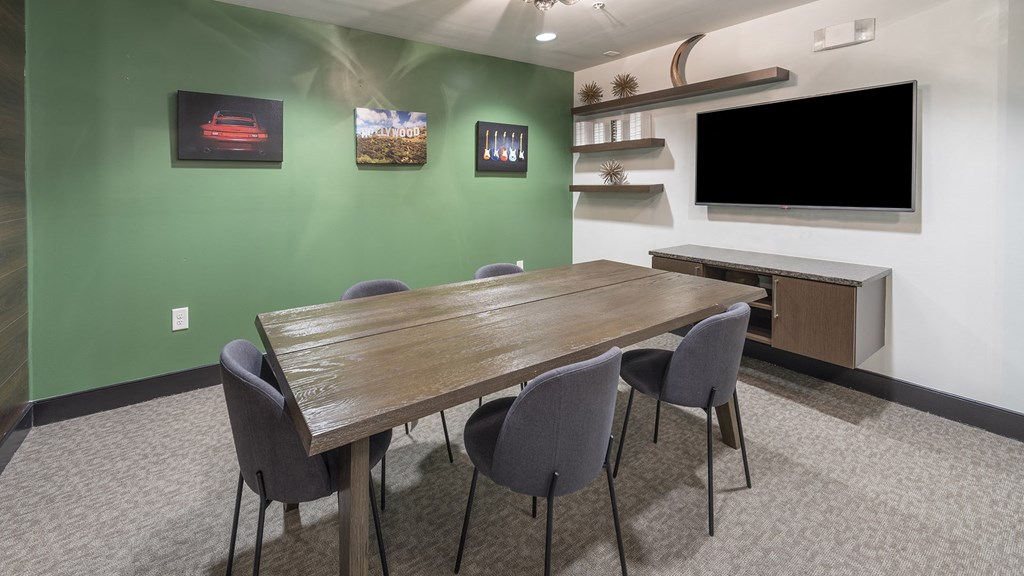 a conference room with a long table and a television at The Hendrix, Atlanta, Georgia