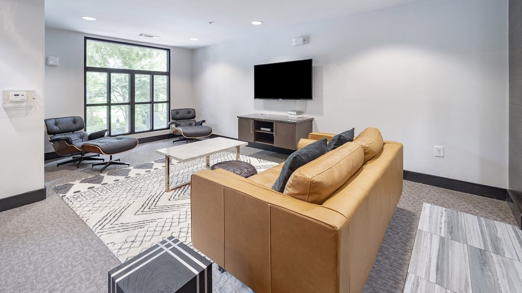 a living room with a couch and a television at The Hendrix, Atlanta, GA