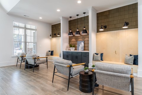 A living room with grey chairs and a wooden cabinet.