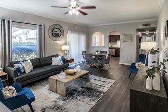 Spacious Living Room with Ceiling Fan and LVT Flooring  located at Retreat at Steeplechase in Houston, TX 77065 - Photo Gallery 5