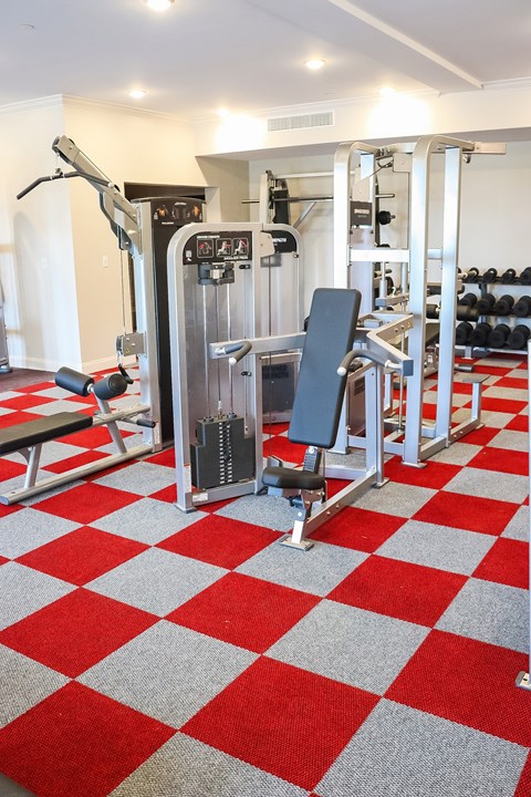 A gym with a red and white checkered floor.