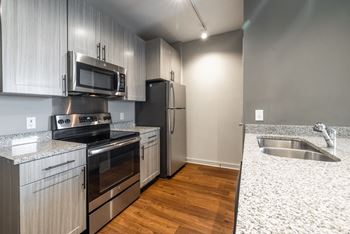A kitchen with a stove, oven, microwave, and refrigerator. at The Tennessee Brewery, Memphis, 38103