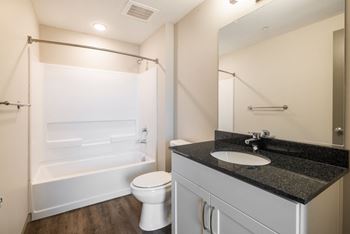 A bathroom with a toilet, bathtub, and sink at The Tennessee Brewery, Memphis, Tennessee