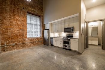 A kitchen with concrete floors and brick wall at The Tennessee Brewery, Memphis