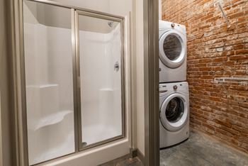 enclosed shower and stackable washer and dryer at The Tennessee Brewery, Memphis