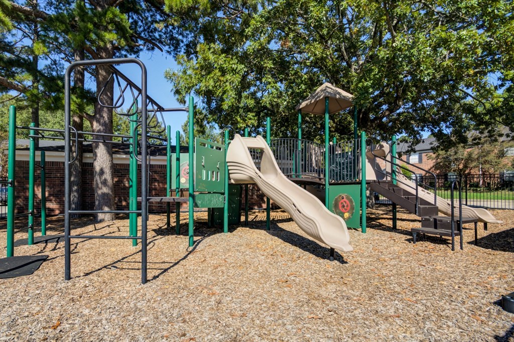 A playground with a slide and swings.