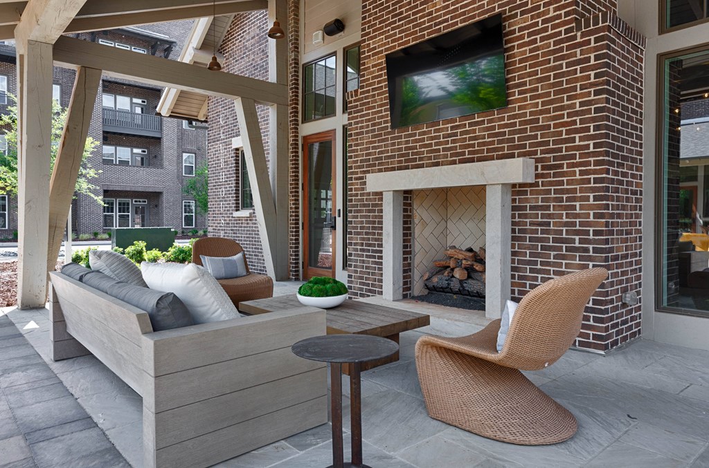 a living room with a fireplace and a couch and a table