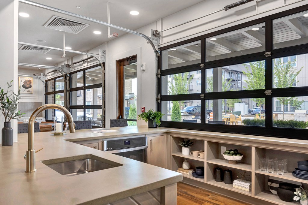 a kitchen with a large window and a sink and counters