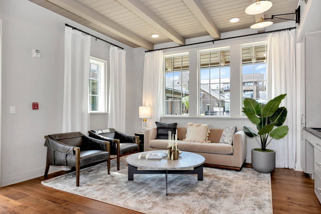 a living room with a couch and chairs and a table