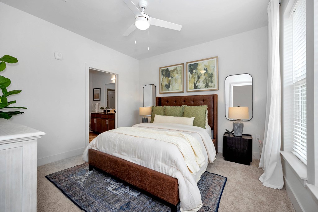 a bedroom with a bed and a ceiling fan