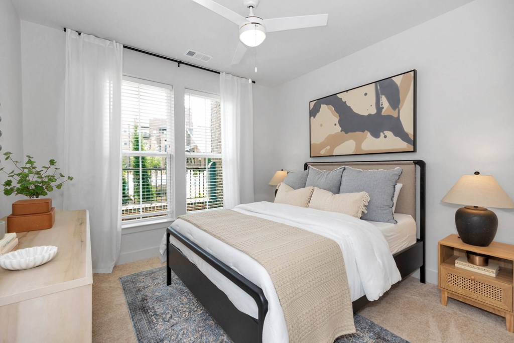 a bedroom with a bed and a large window