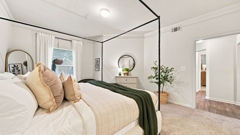 A bedroom with a large bed and a mirror on the wall.