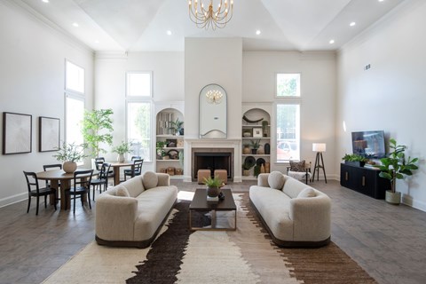 A living room with a fireplace and a large rug.