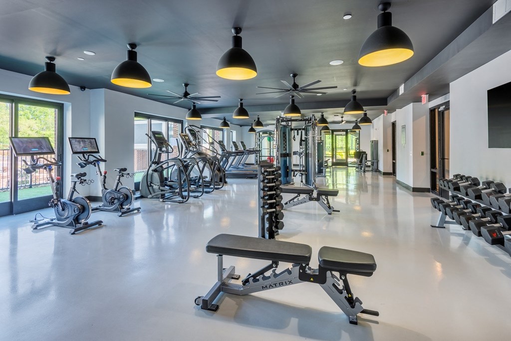 a gym with cardio equipment and weights on the floor  at The Livano Tryon, Charlotte, North Carolina