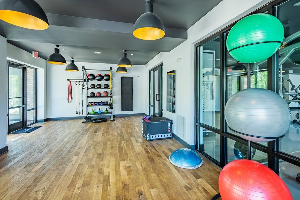 a room filled with furniture and a large window at The Livano Tryon, Charlotte, NC, 28213