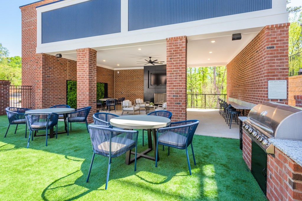 a patio with tables and chairs and a grill at The Livano Tryon, Charlotte, North Carolina