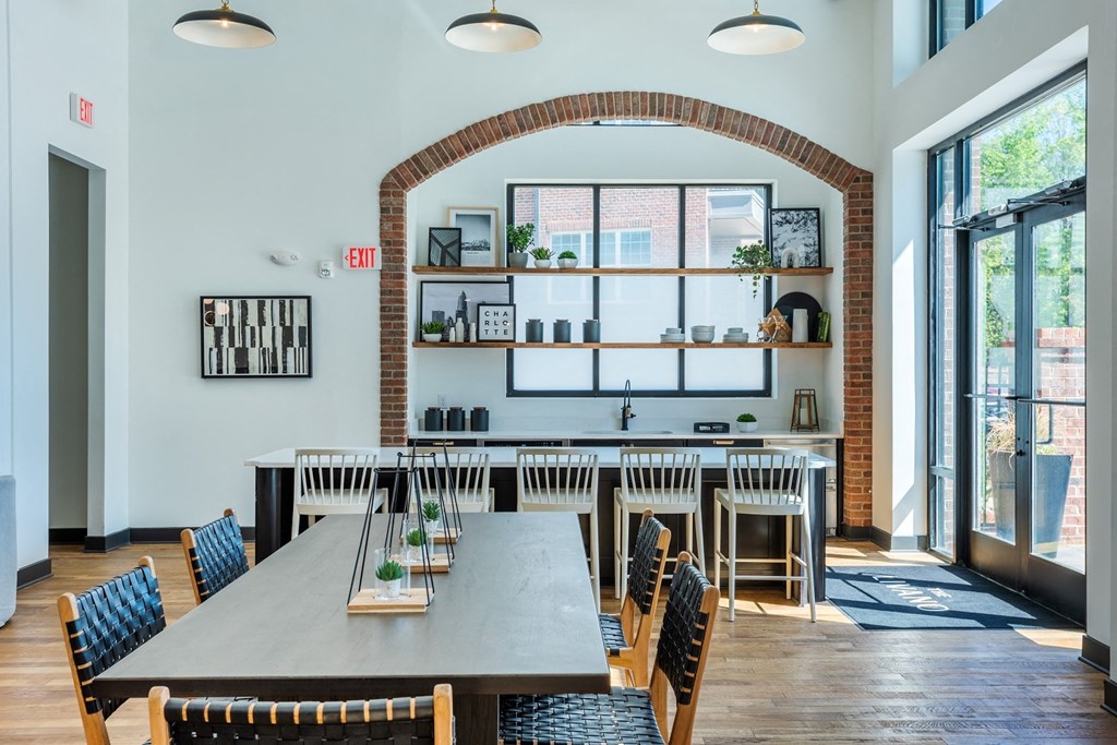a dining room with a long table and chairs at The Livano Tryon, Charlotte, 28213