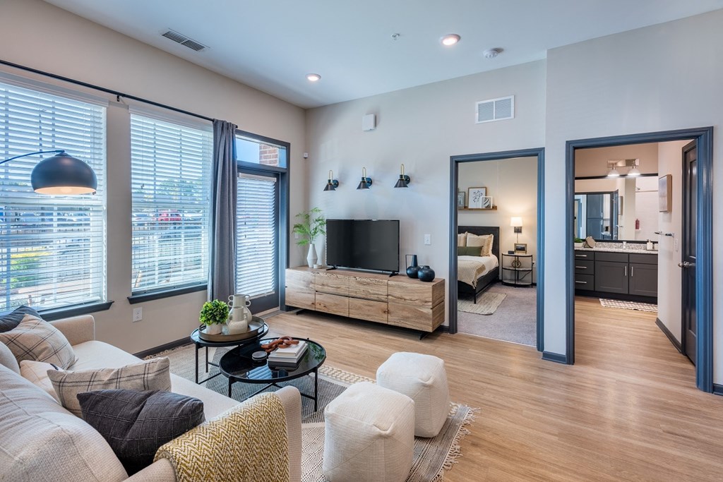 a living room with large windows and a couch at The Livano Tryon, Charlotte, 28213