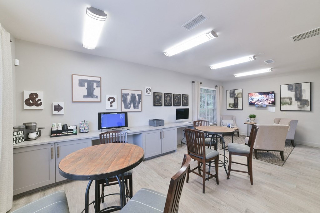a common room with tables and chairs and a television at Twenty35 at Timothy Woods, Georgia