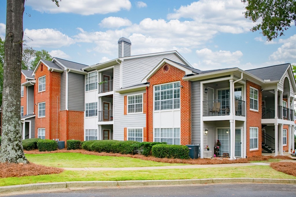 an apartment building with red brick and white siding at Twenty35 at Timothy Woods, Athens, 30606