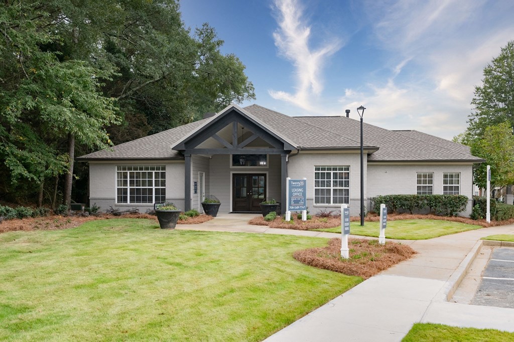 the front of a white house with a lawn and sidewalk at Twenty35 at Timothy Woods, Athens, GA
