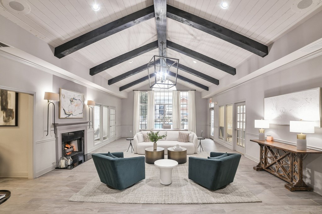 a living room with a fireplace and a ceiling with beams at Twenty35 at Timothy Woods, Athens, Georgia