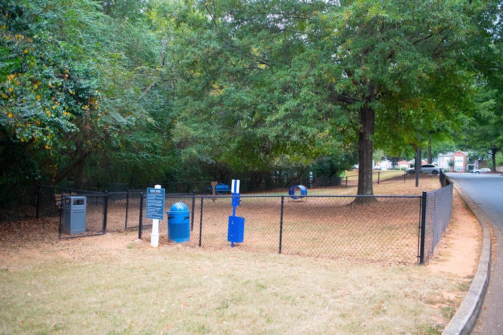 a park with a chain link fence and blue trash cans at Twenty35 at Timothy Woods, Athens, Georgia