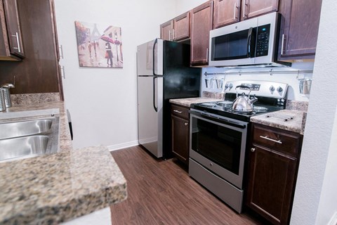 a kitchen with stainless steel appliances and granite counter tops