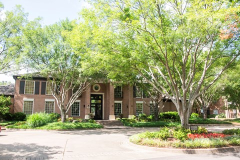 A building with a tree in front of it.