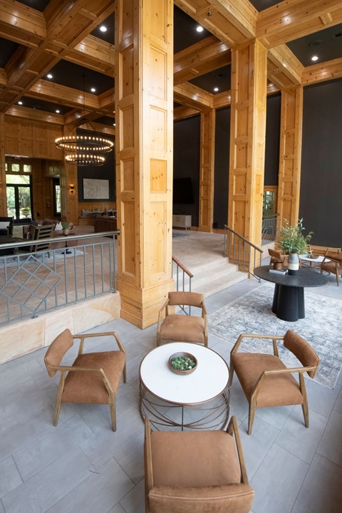 A large room with a table and chairs in the center.