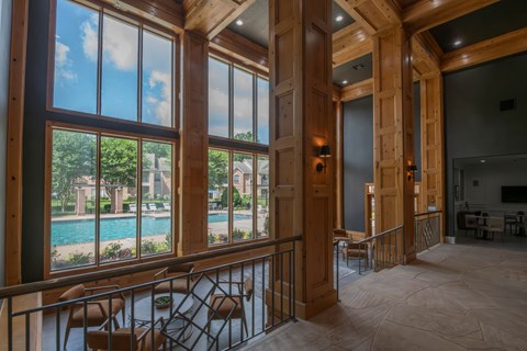 A large room with a pool and a balcony.