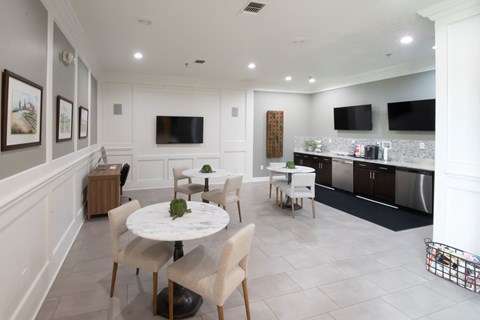 A modern dining room with a white table and chairs.