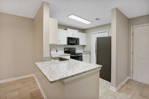 a kitchen with a counter top and a refrigerator