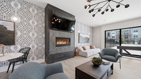 A modern living room with a fireplace and a grey couch.