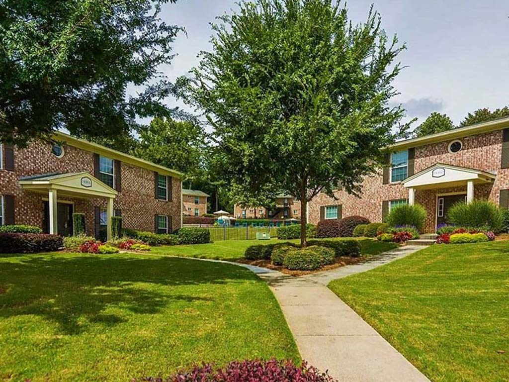 Bright Clubhouse Exterior with Trees Inviting You Inside the Artesian East Village, Atlanta, GA 30316