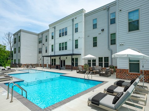a swimming pool in front of a white building at Lakeland Town Square, Lakeland, Tennessee