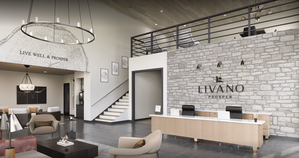 the lobby of a hotel with a stone wall and a reception desk at Livano Prosper, Prosper Texas