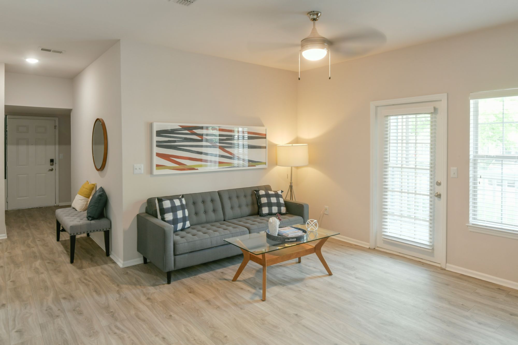 A living room with a grey couch and a coffee table.
