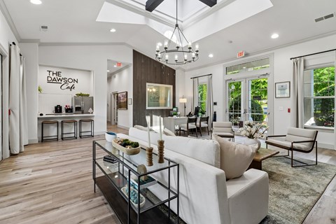 A modern living room with a white sofa and a glass coffee table.