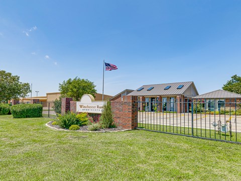 The image shows a building with a sign that reads "Winchester Run" in front of it.