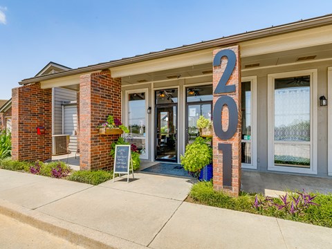 A building with a sign that says "201" in front of it.