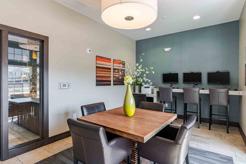 A dining room with a wooden table and chairs.