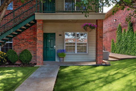 A house with a green door and a small porch.