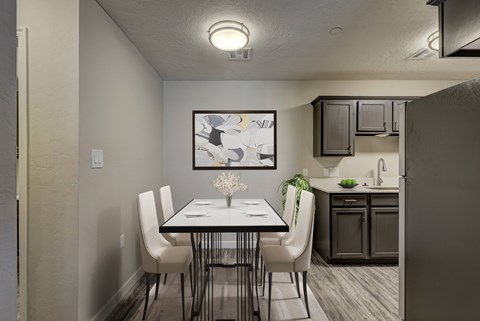 A dining room with a table set for four.
