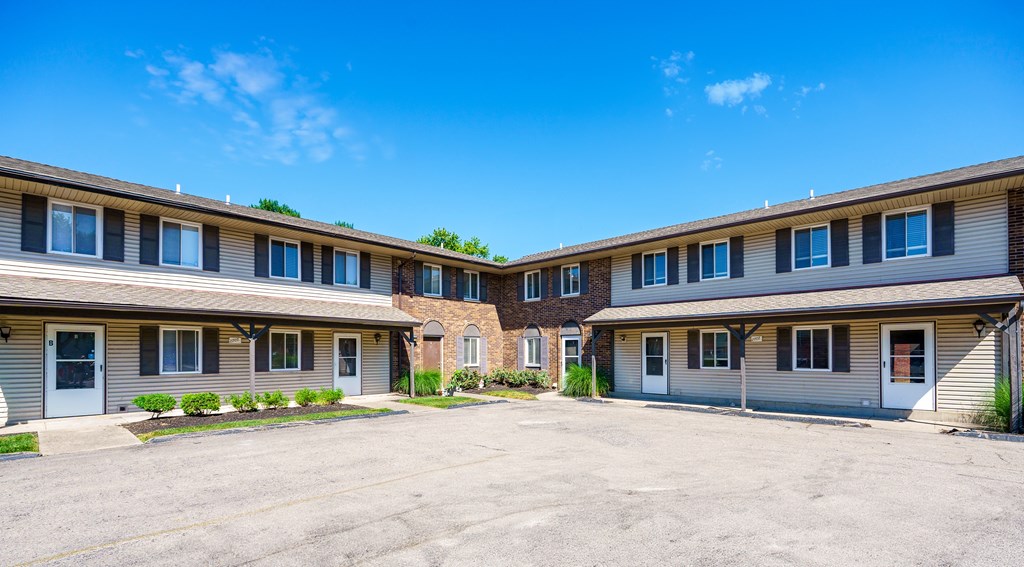 A sunny day at the outdoor parking lot of a building complex.