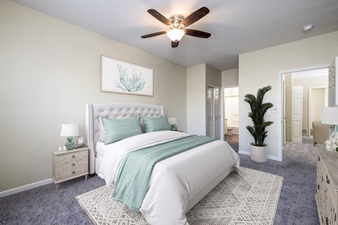 an open bedroom with a bed and a ceiling fan
