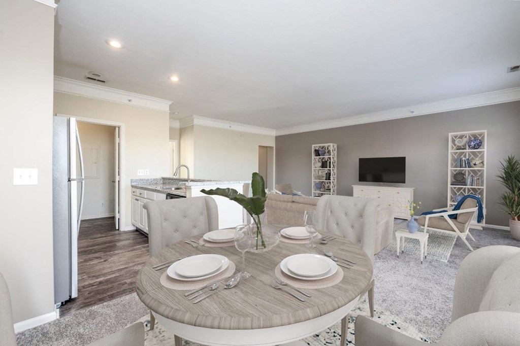 a dining room and living room with a table and chairs