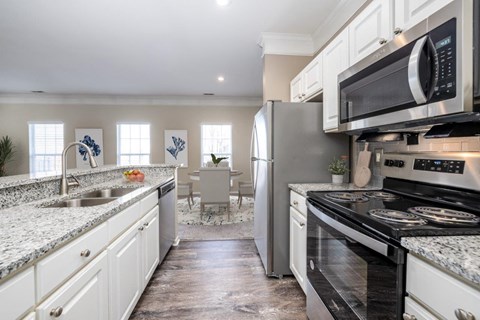 a kitchen with stainless steel appliances and granite counter tops