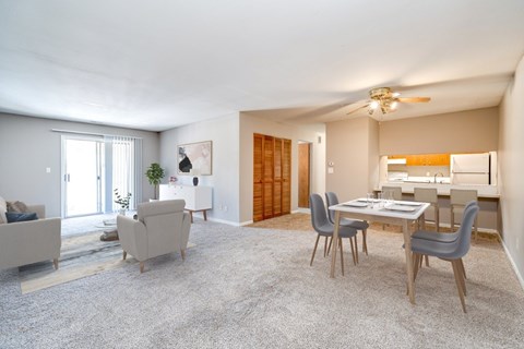 A living room with a grey carpet and furniture.