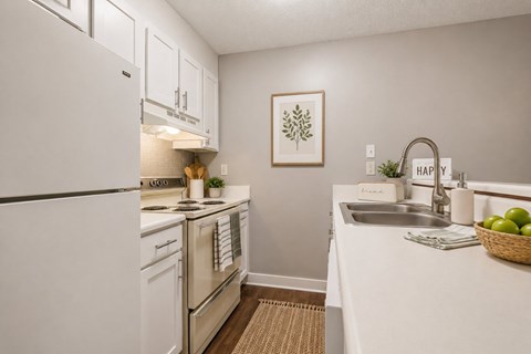 A kitchen with white appliances and a white counter top.